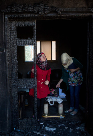 Palestinian girls look at the damage at the Dawabsha family's home in the West Bank village of Duma, on August 06, 2015. Two of the families homes after were set on fire by suspected Jewish extremists a few days ago, killing 18-month-old Ali Saad Dawabsha and leaving his parents and four-year-old brother severely burned in the firebombing attack. Photo by Miriam Alster/FLASH90 *** Local Caption *** ???? ????? ???? ???????