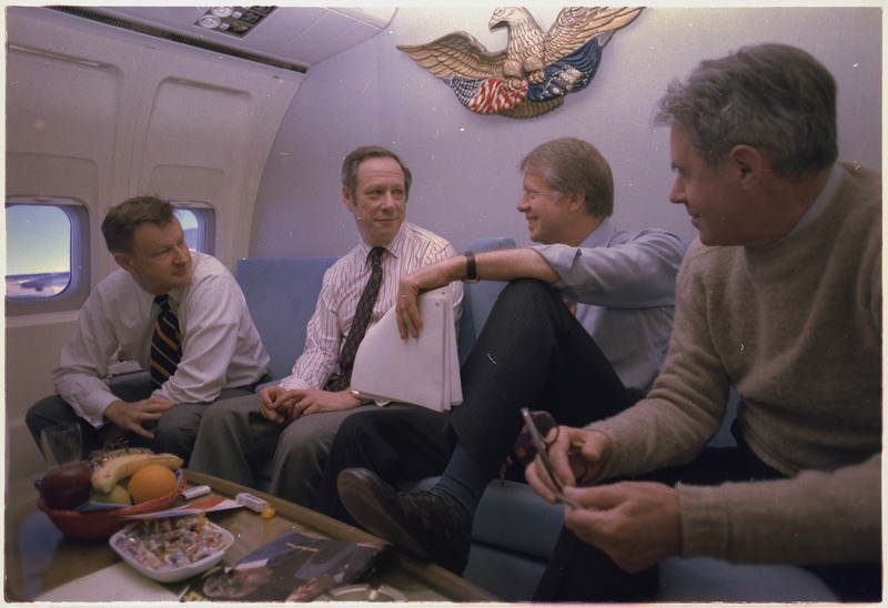 lossy-page1-800px-Zbigniew_Brzezinski,_Michael_Blumenthal,_Jimmy_Carter_and_Cyrus_Vance_aboard_Air_Force_One_during_a_trip_to_London..._-_NARA_-_174612.tif